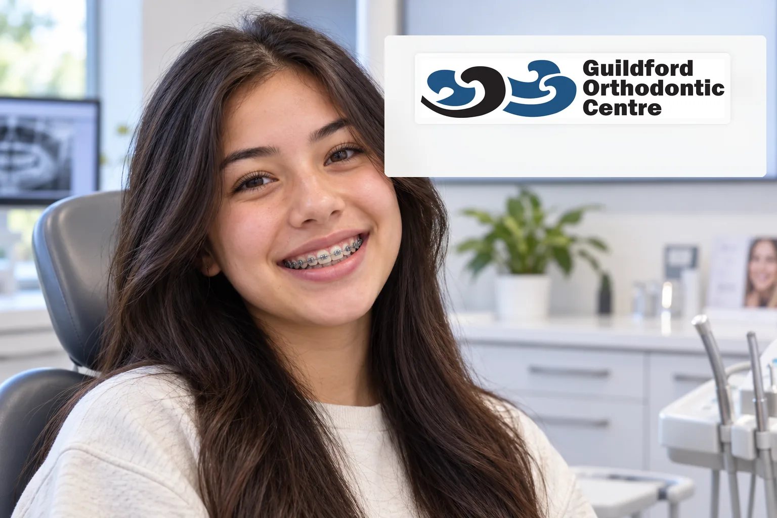 Teen patient smiling naturally with conventional metal braces at an orthodontic clinic.