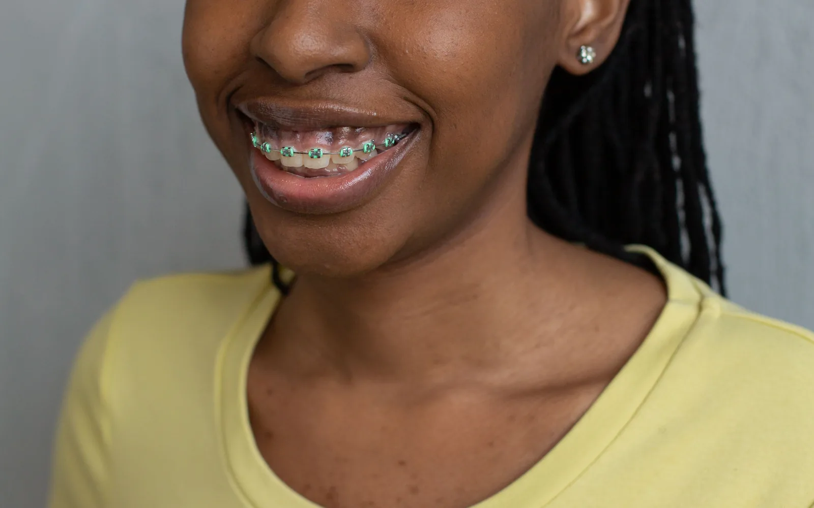 Young woman smiling confidently with orthodontic braces