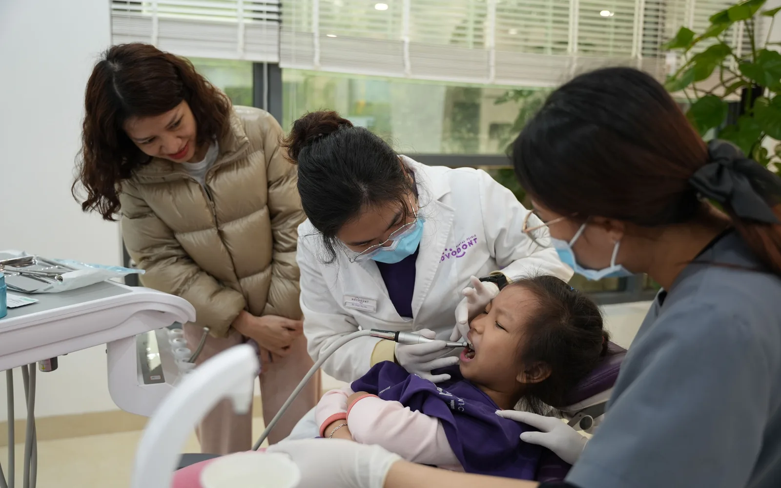 Child at a dental visit with a parent and clinical team