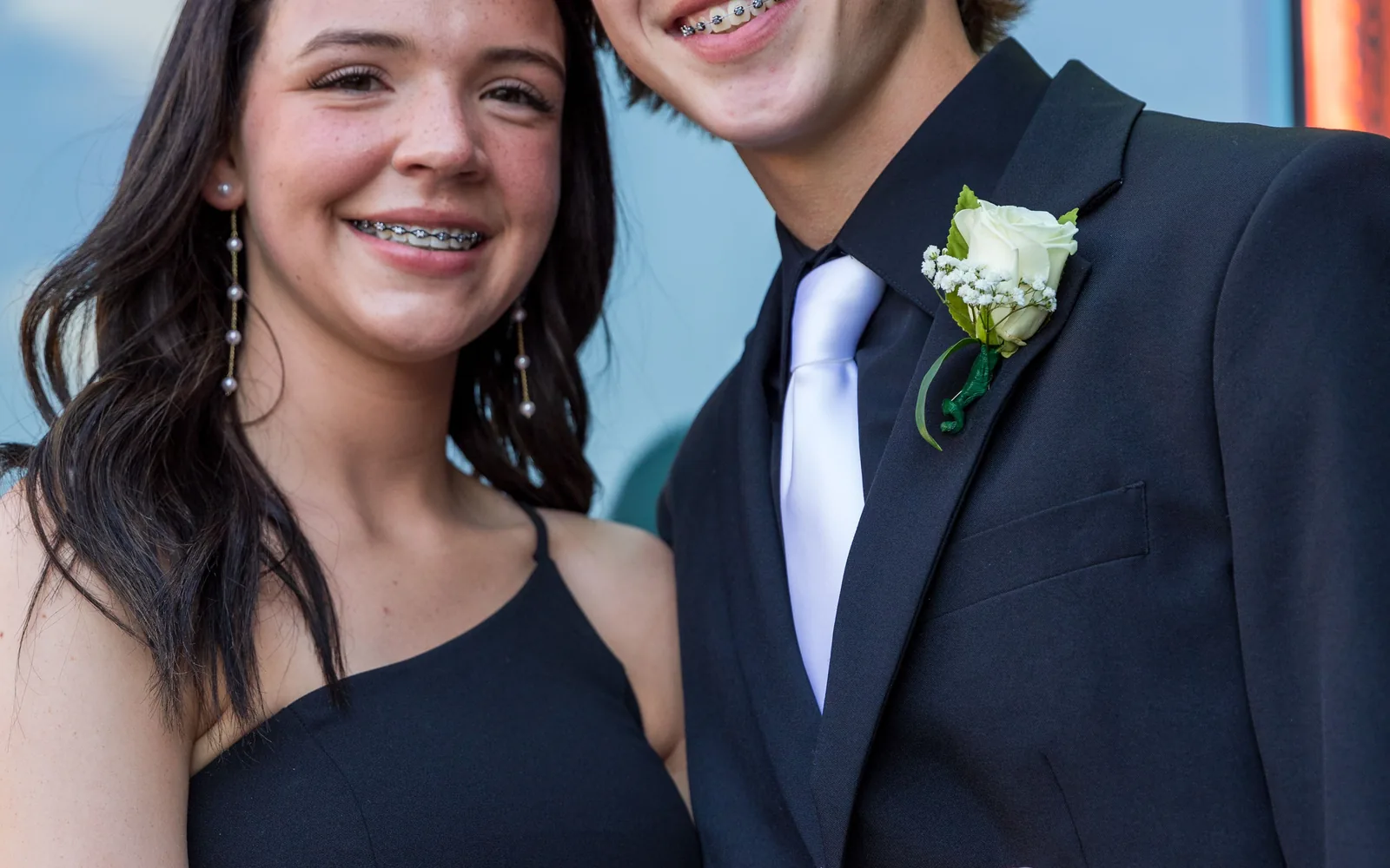 Two teenagers smiling with orthodontic braces